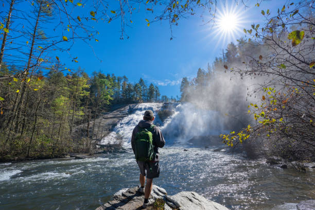 istock Man hiker relaxing by the waterfall. 1468919173