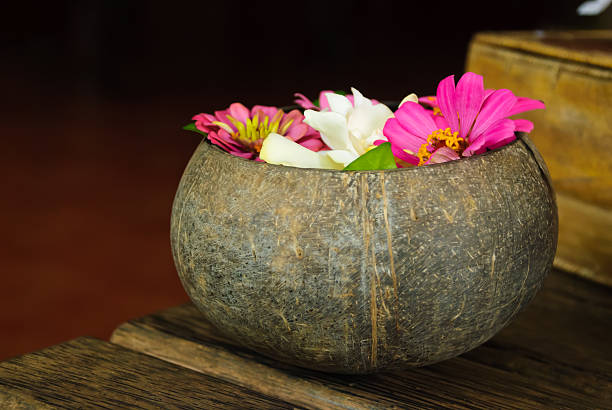 Tropical flowers in a coconut vase