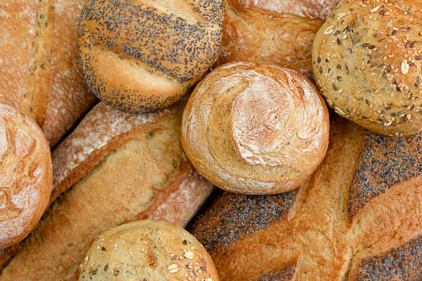istock Different kinds of fresh bread as background, Top view. 1468922795