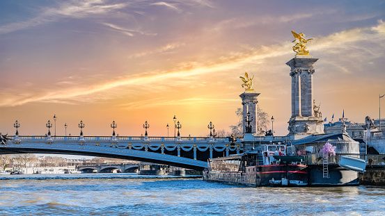 Paris, the Alexandre III bridge on the Seine, with houseboats on the river