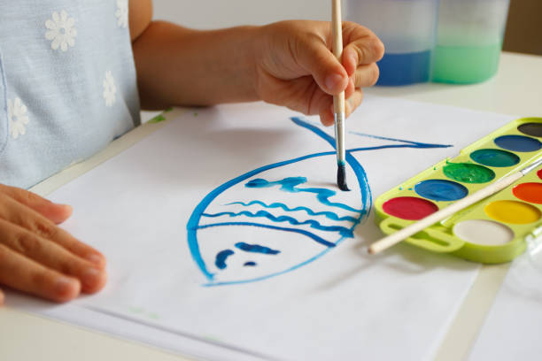 istock Child drawing a picture by watercolor, school lesson concept 1468923768