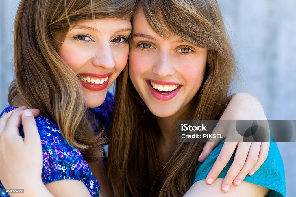 Two women hugging and smiling http://www.edkafelek.com/beauty.jpghttp://www.edkafelek.com/teenagers.jpghttp://www.edkafelek.com/peopleoutdoors.jpg Adult Stock Photo