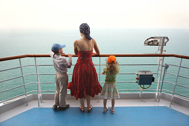 Mother with two children on deck of cruise ship