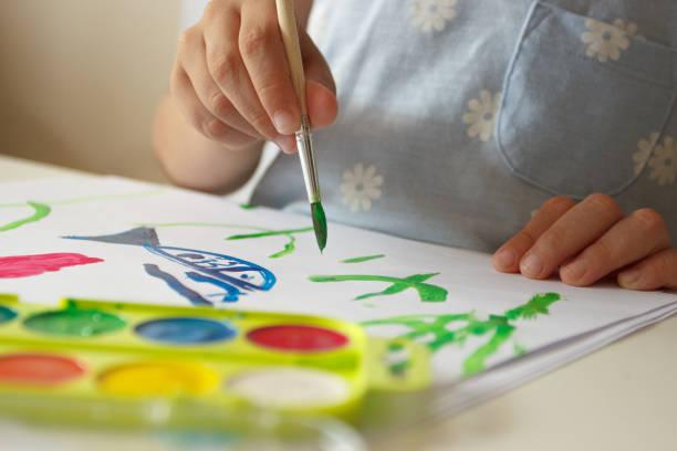 istock Child drawing a picture by watercolor, school lesson concept 1468924733