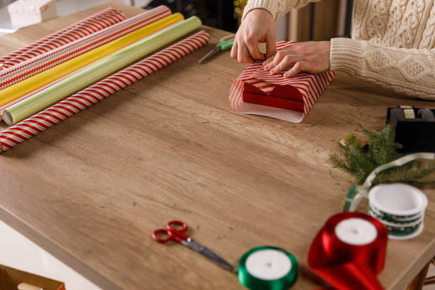 istock Crafty young man neatly wrapping a gift box 1468924861