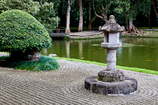 Japanese Pagoda in zen garden with pond in background