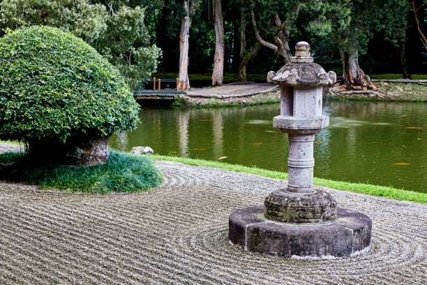 japanese pagoda in zen garden with pond in background - japanese culture landscape landscaped ornamental garden imagens e fotografias de stock