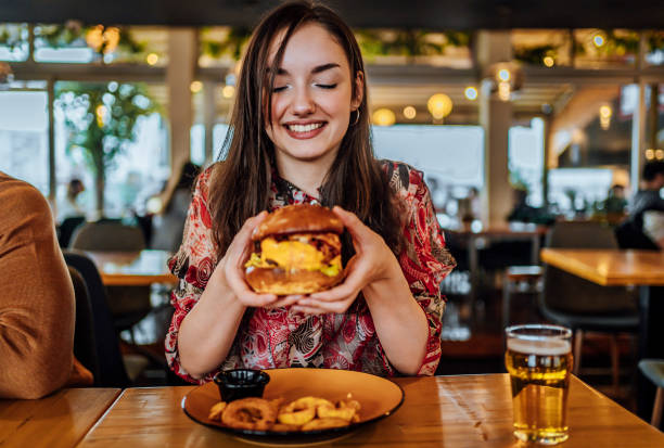 istock Young woman ready to eat a burger 1468925727