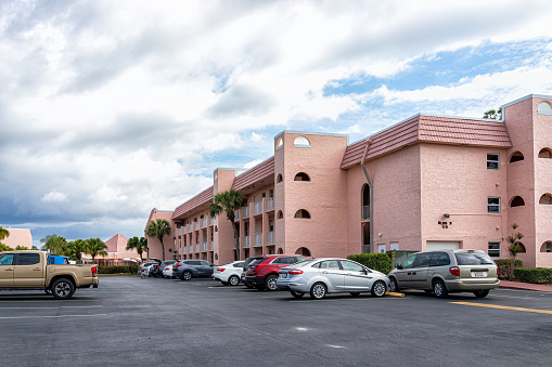 Naples, USA - February 5, 2022: Turtle Lake condo condominium association residential buildings parking lot in Southwest Florida city in summer