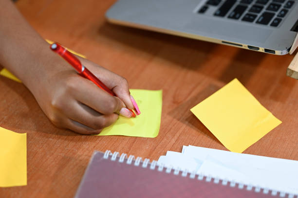 istock Person writing on a paper 1468926045