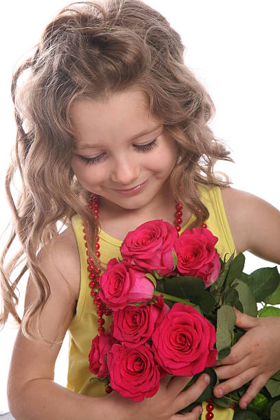 istock Cute curly girl looking at roses 146892649