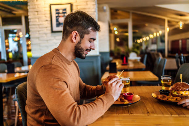 istock Young man ready to eat a burger 1468927560