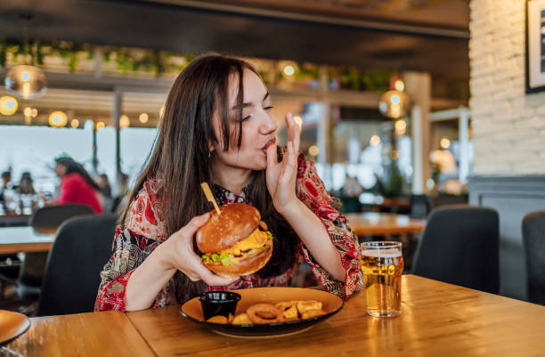 istock Young woman enjoying a delicious burger 1468927717