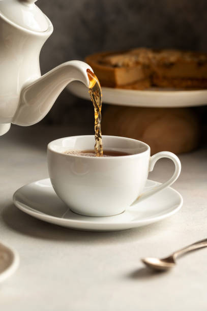 istock Pouring hot tea in white, ceramic cup, slow living concept 1468927876