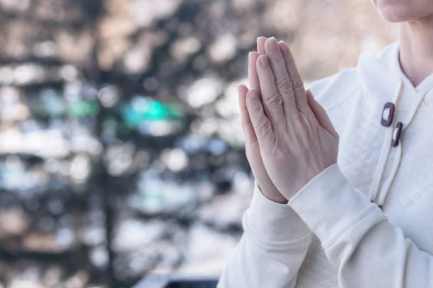 istock Woman praying with raised hands . 1468928465