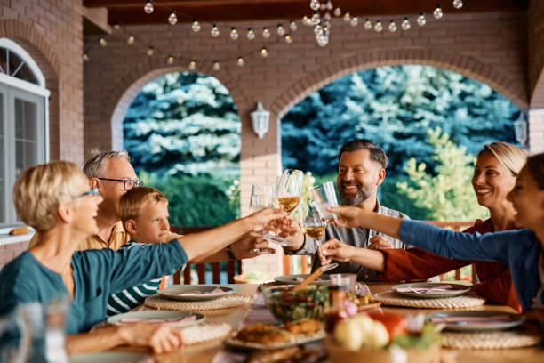 istock Happy multigeneration family toasting while gathering for lunch at dining table on a patio. 1468929549