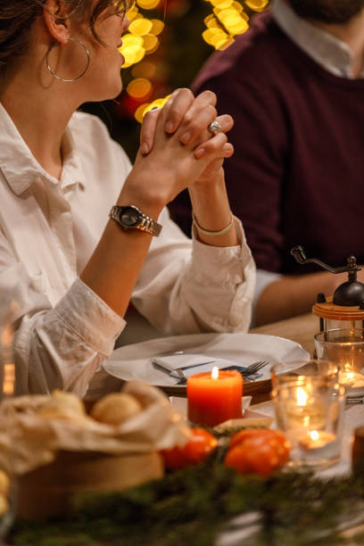 istock Young woman gesturing while sharing an interesting story with friends during a Christmas dinner party 1468932003