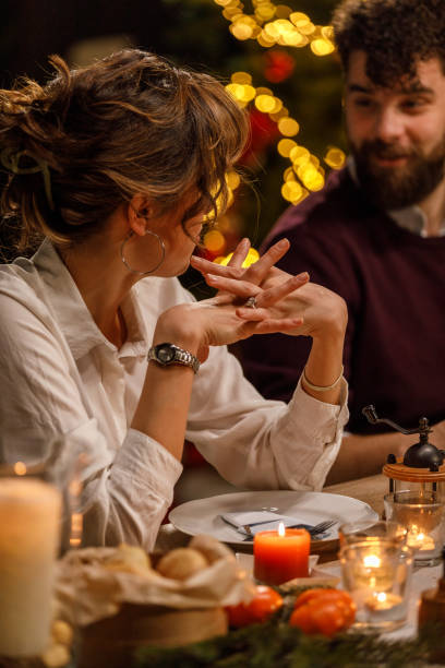 istock Young woman gesturing while sharing an interesting story with friends during a Christmas dinner party 1468932005