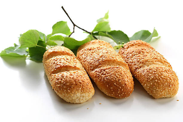 Three bread rolls with birch leaves stock photo