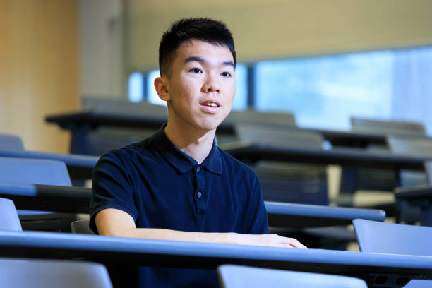 istock Asian male university student paying attention in the lecture hall 1468933248