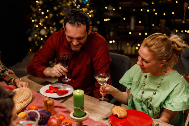 istock Friends enjoying drinks and chatting during a Christmas dinner party 1468934131