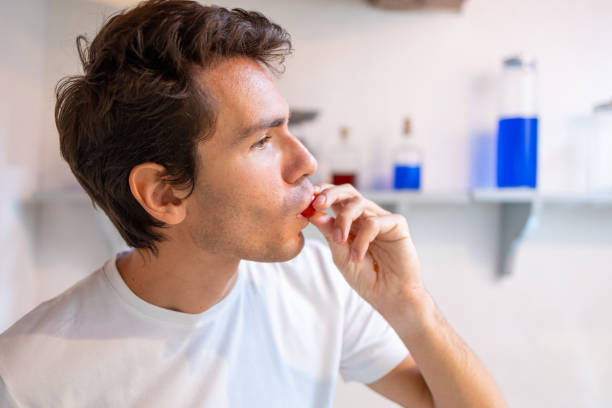 istock Young man eating a fresh cherry tomato 1468935311