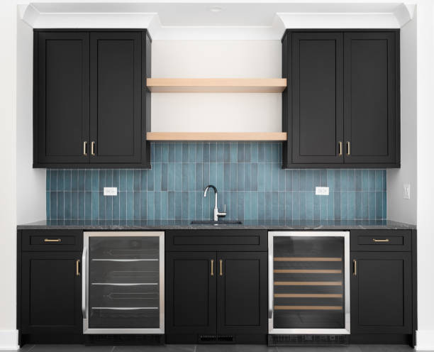 istock A wet bar with black cabinets and a blue tiled backsplash. 1468935622