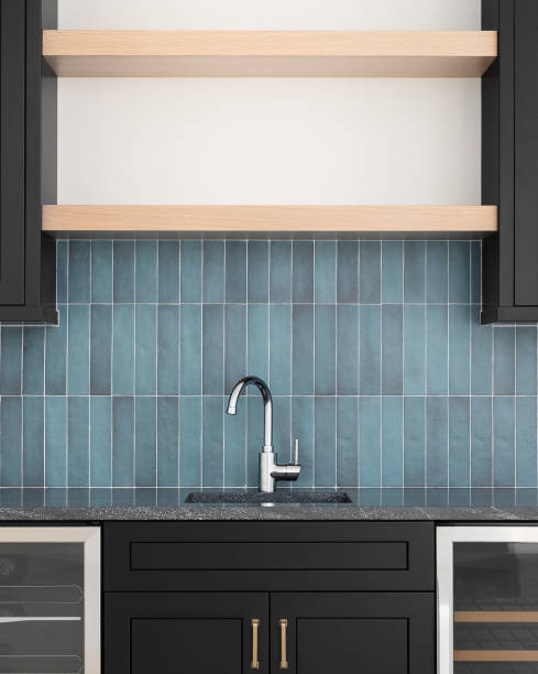 istock A faucet detail with black cabinets and a blue tile backsplash. 1468935623