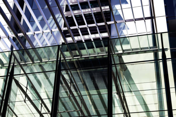 Low angle view of office buildings, view through pedestrian sunshade, abstract background, full frame horizontal composition