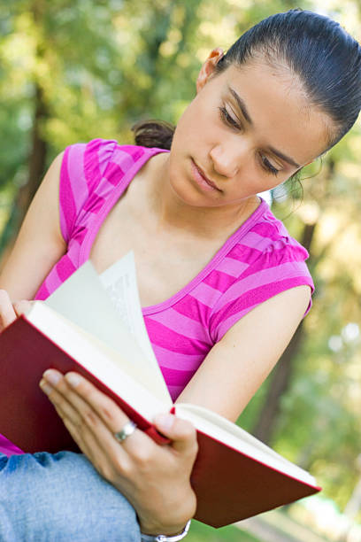 istock young woman reading outdoor 146893828