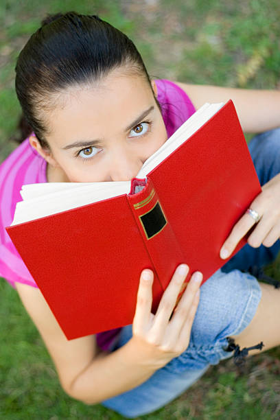 istock young woman reading outdoor 146893830