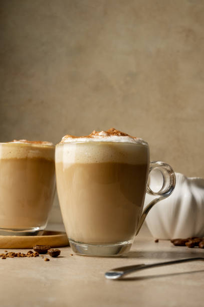 istock Two glass cups with coffee drink, latte with milk foam. 1468940957