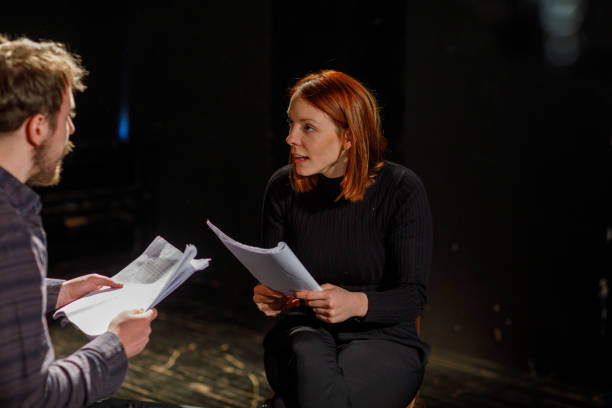 istock Actors Rehearsing With Scripts On Stage In Theatre 1468941003