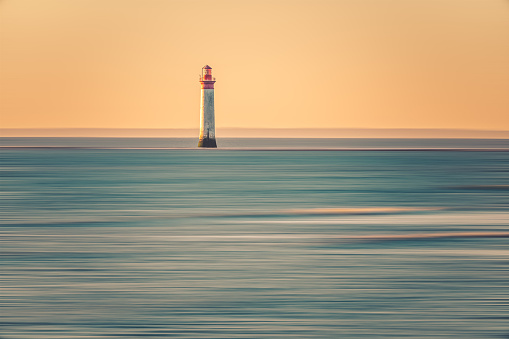 Chauveau lighthouse, isle of Re, at sunset on a very calm sea.