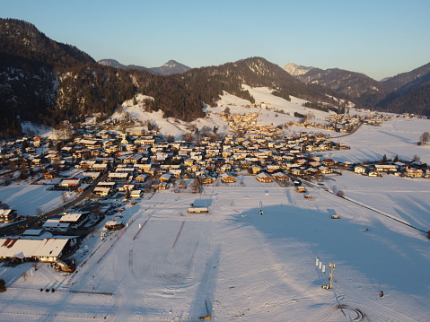 Aerial view of Reit im Winkl full of snow during sunset in the winter