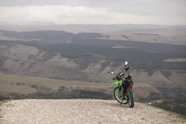 Enduro bike stands on a cliff.