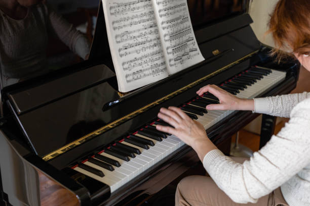 istock woman hands plays piano 1468947215
