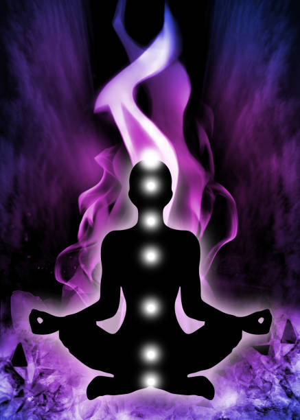 Human silhouette in yoga / lotus pose with 7 chakras positions and Violet Flame Background. stock photo