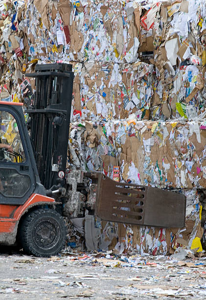 istock Forklift lifting cubes of recycled paper 146894912