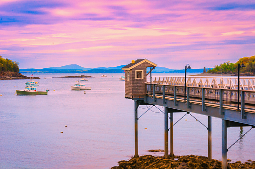 The waters of Frenchman's Bay take on purple sunset colors as evening nears in Bar Harbor, Maine.