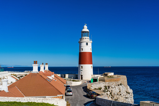 Gibraltar, United Kingdom - Nov 18, 2022: Europa Point Lighthouse, Trinity Lighthouse or Victoria Tower. Strait of Gibraltar on the background. British Overseas Territory of Gibraltar.