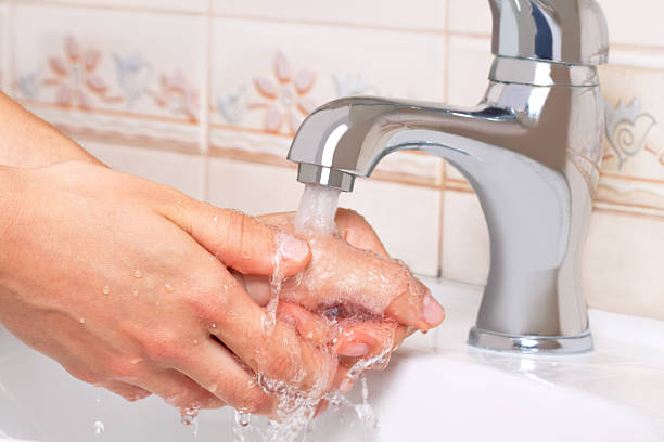 istock Woman washing hands in bathroom 146895959