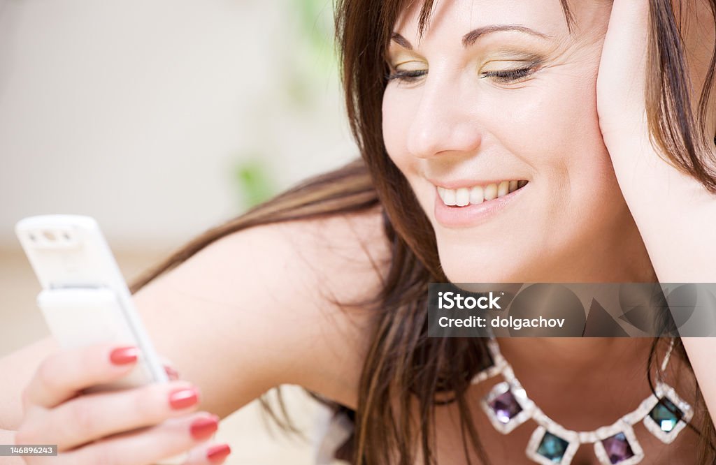 woman with white phone portrait of happy woman with white phone Adult Stock Photo