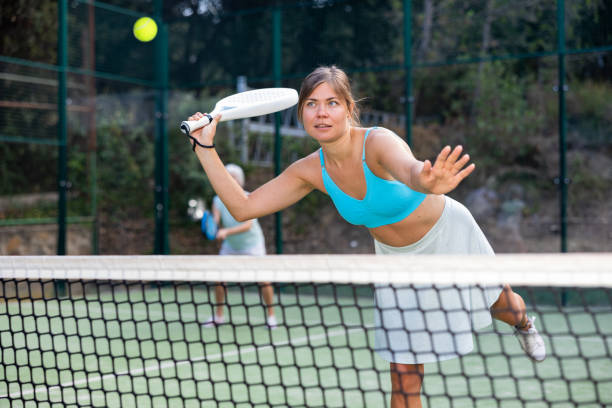 istock Training while playing on tennis court. Woman learning to play paddle 1468965966