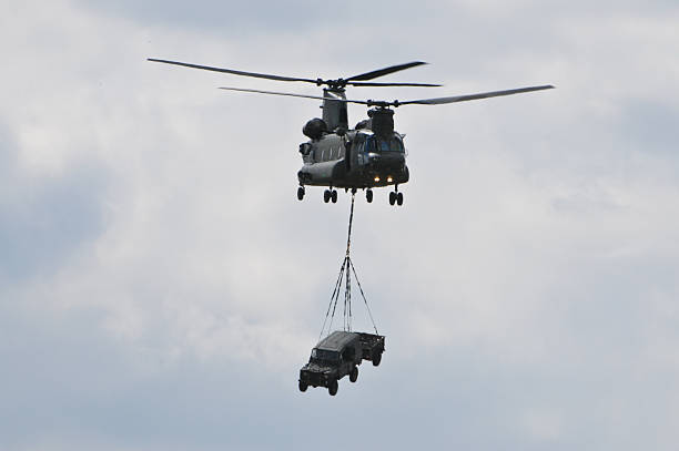 istock Chinook Helicopter transporting car 146896860
