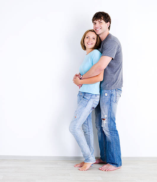 istock Young beautiful couple  in empty room 146897417