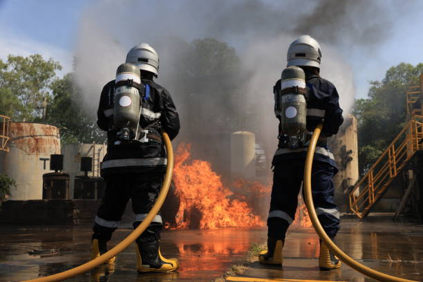 istock Firefighters Extinguishing hard working to fix Fire ,Fireman wearing firefighter turnouts and helmet.  Advant Fire Fighting and Fire Drill Training 1468980291