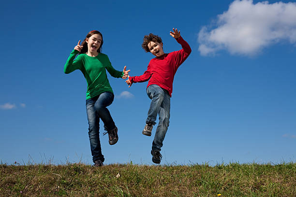 istock Kids jumping outdoor against blue sky 146898039