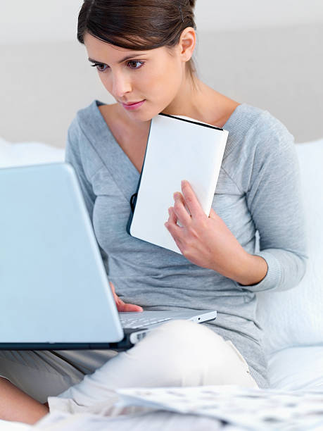 istock Young lady working on a laptop at home 146898546