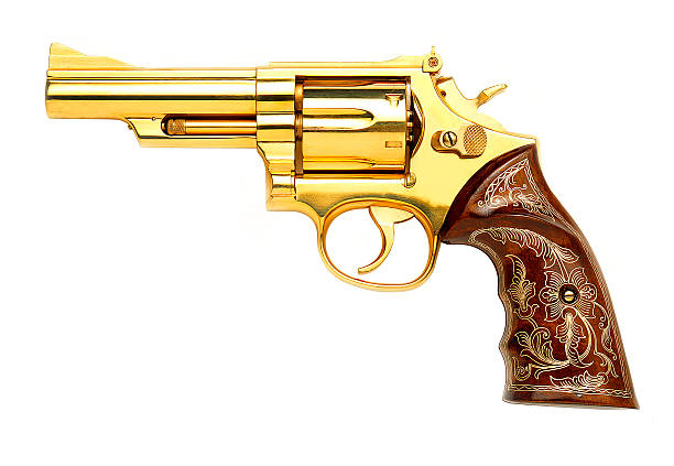 Golden gun Golden revolver gun with engraved pistol grip on white background engraved image photos stock pictures, royalty-free photos & images